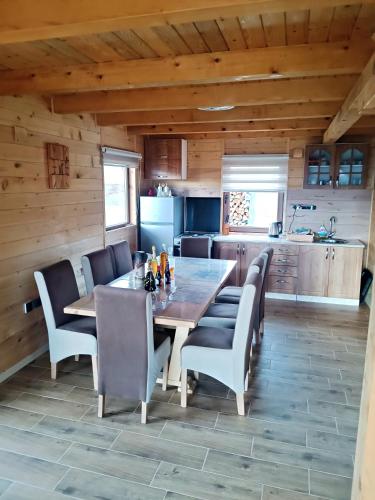 a kitchen and dining room with a table and chairs at Vila Planinski san 2 in Zaovine