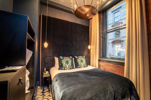 a bedroom with a bed and a window at Forty-Seven in Manchester