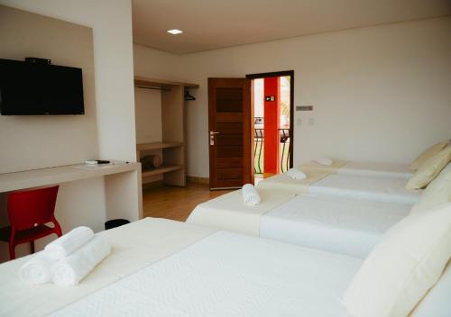 Postel nebo postele na pokoji v ubytování Hotel Chalé Capitólio