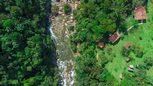 an overhead view of a river in a forest at La Perla Negra - Black Pearl Eco Hostel in San Rafael