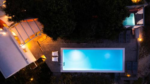 an overhead view of a swimming pool at night at 270 Oias View in Oia