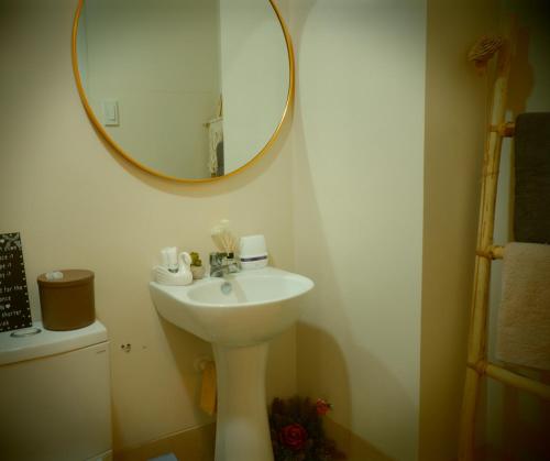 a bathroom with a sink and a mirror at Stanford Suites, South Forbes - Standard Room with pool in Silang