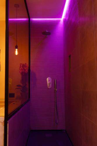 a purple bathroom with a shower with a purple light at Hotel Giotto Flavia in Rome