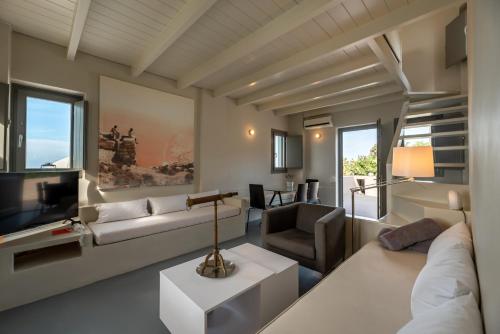 a living room with a couch and a television at 270 Oias View in Oia