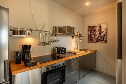 a kitchen with a sink and a stove top oven at 270 Oias View in Oia