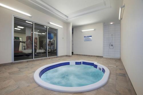 a large jacuzzi tub in the middle of a room at Travelodge Hotel by Wyndham Weyburn in Weyburn