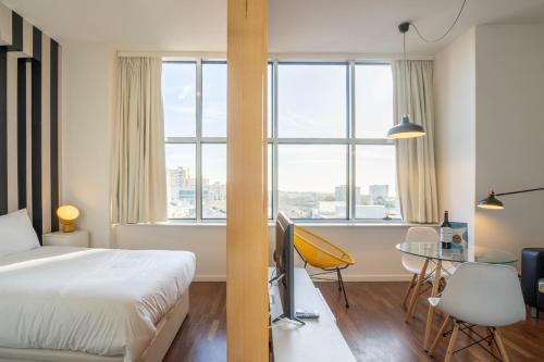 a bedroom with a bed and a table with a desk at Boavista 1774 by LovelyStay in Porto