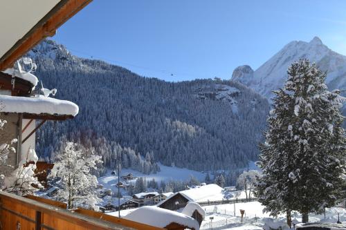 a view of a snow covered mountain from a house at Albergo Majorka in Canazei