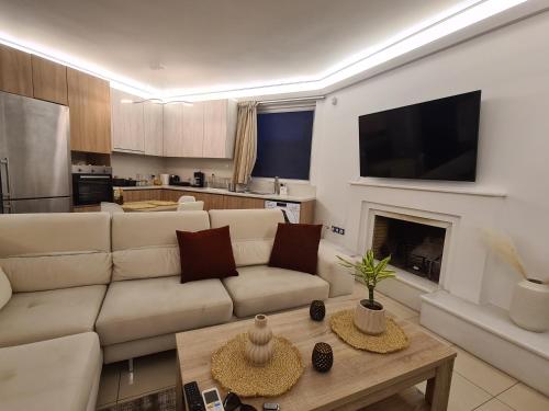 a living room with a couch and a fireplace at Sunny Home Private Jacuzzi Hydromassage, Fireplace, Acropolis & Lycabettus View, Underground Parking, 300m Metro Peristeri in Athens