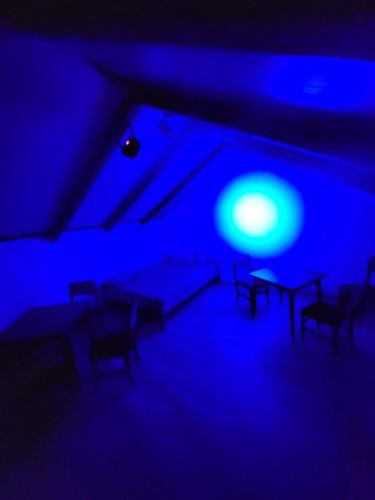 a blue room with chairs and a table in it at cunami kucica in Belgrade