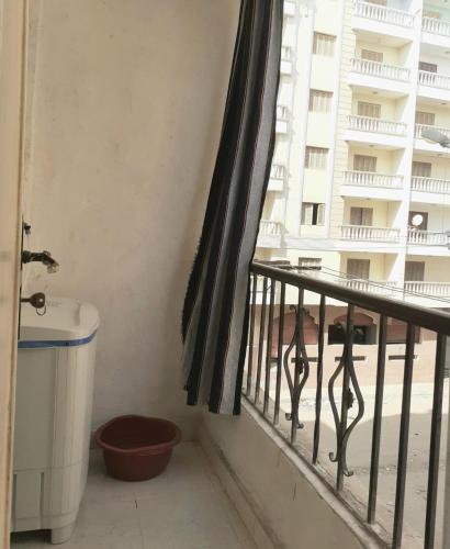 a balcony with a toilet and a window with a building at Apartment in Minya with archaeological tours in Al Minya