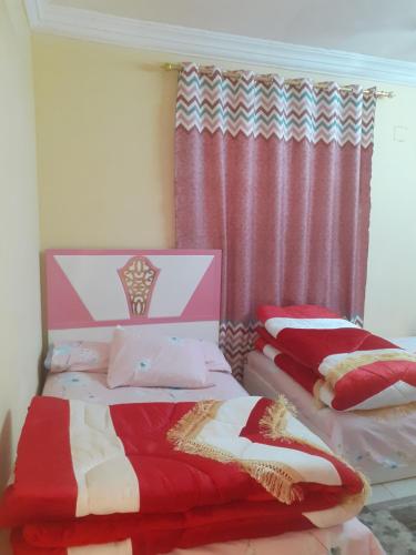 two beds sitting next to each other in a bedroom at Apartment in Minya with archaeological tours in Al Minya