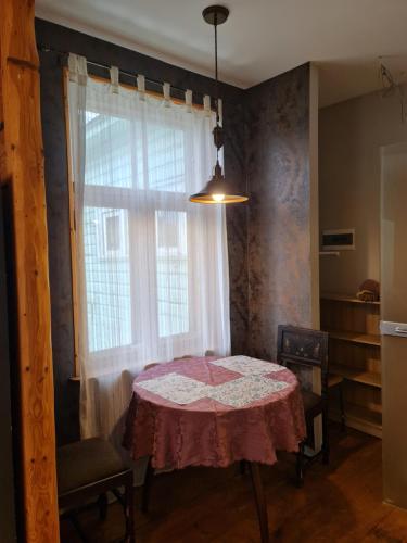a dining room with a table and a window at Cosy studio near Aqva Spa in Rakvere
