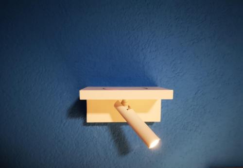a wooden holder with a bat on a blue wall at sonnberg in Ischgl