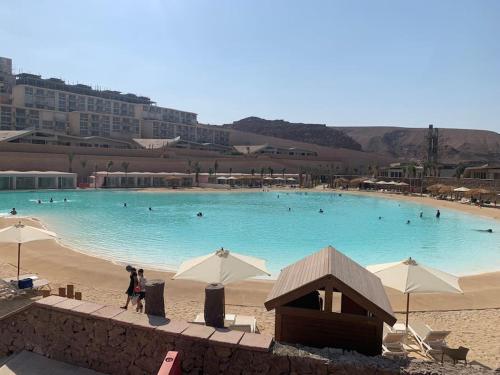 a large blue swimming pool with people in it at IL Monte Galala Apartment - Families only 3 bed rooms in Ain Sokhna
