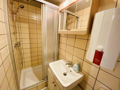 a small bathroom with a sink and a shower at Ferienhaus Segelboot in Warnemünde