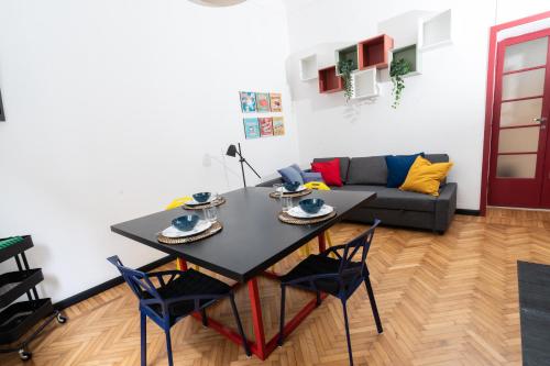 a living room with a table and a couch at Pop House - Spacious flat next to Cathedral & Lake in Como