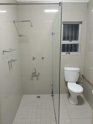 a white bathroom with a toilet and a shower at Cape Town 5 bedroom house Belhar in Cape Town