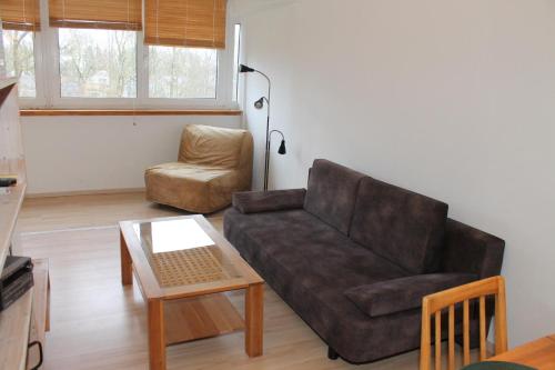 a living room with a couch and a chair at Ferienwohnung F225 für 2-5 Personen an der Ostsee in Brasilien