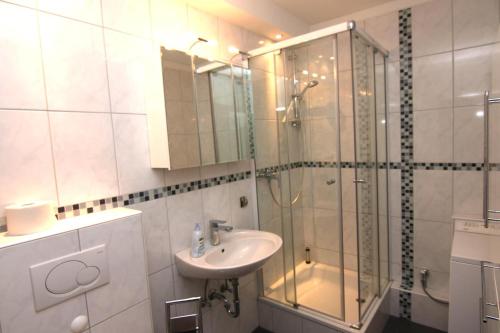 a bathroom with a glass shower and a sink at Ferienwohnung F249 für 2-4 Personen an der Ostsee in Brasilien