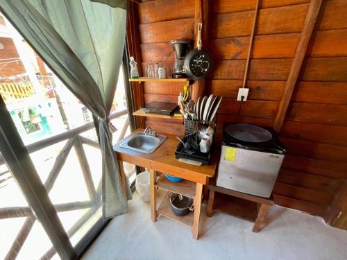 a desk with a sink and a clock on a wall at AKBAL Holbox - Beach Zone in Holbox Island
