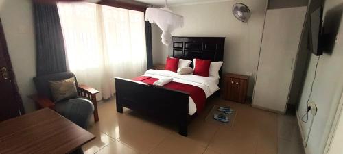 a bedroom with a bed with a teddy bear on it at Milimani Comfort in Kisumu