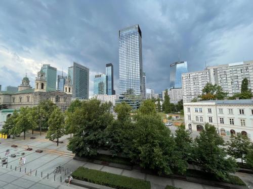 a view of a city with tall buildings and trees at ComeWa Apartments in Warsaw
