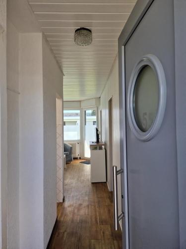 a hallway with a mirror on the wall and a door at Feriengarten Dahme W 5 in Dahme