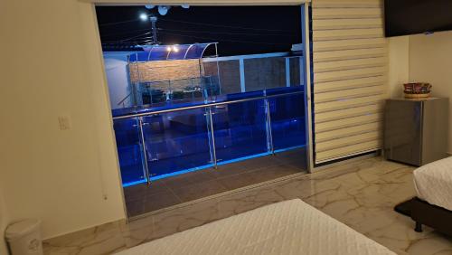 a room with a large window with a balcony at PISCINA SARITA CLUB BOUTIQUE in Girardot