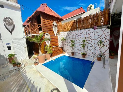 a swimming pool in front of a house at Hotel AKBAL Holbox in Holbox Island
