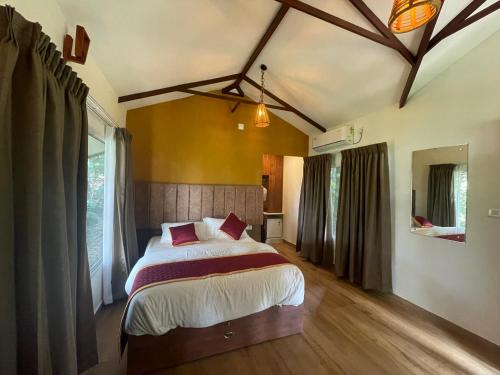 a bedroom with a large bed in a room at Coffee Cradle Wayanad Luxuorios Private Tree House - Inside 2 Acre Coffee Plantation in Mananthavady