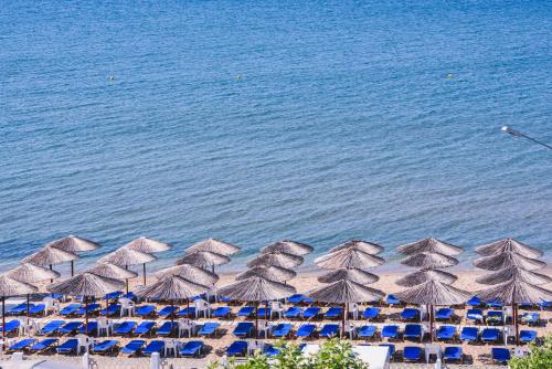 a group of umbrellas and chairs on a beach at Santa Rosa Hotel & Beach in Alexandroupoli