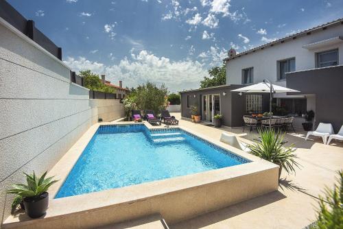 a swimming pool in the backyard of a house at House Zoya in Ližnjan