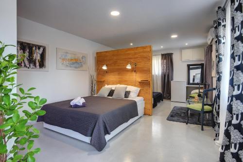 a bedroom with a bed with a wooden headboard at House Zoya in Ližnjan