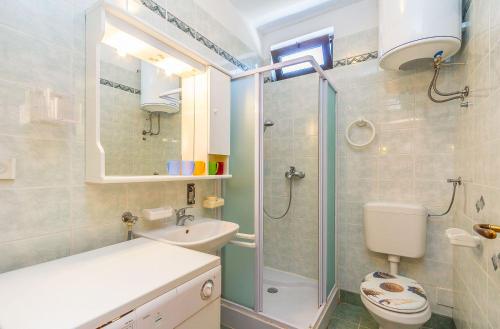 a bathroom with a shower and a toilet and a sink at Apartment Eliana in Banjole