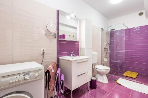 a purple bathroom with a sink and a toilet at Apartment Doris in Banjole