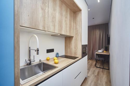 a kitchen with a sink and a counter at City Rooms Acropolis in Odesa