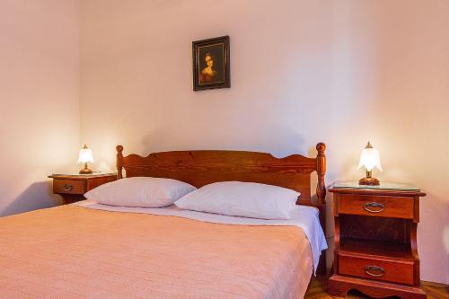 um quarto com uma cama com duas mesas de cabeceira e dois candeeiros em Casa Anka em Medulin