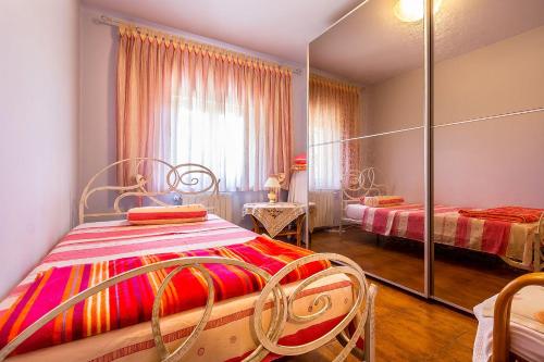 a bedroom with two beds and a mirror at Villa Nera in Banjole