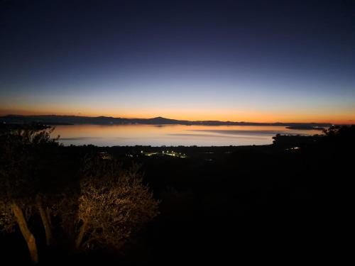 a view of a body of water at sunset at Casa Vacanze La Perla del Lago in Passignano sul Trasimeno