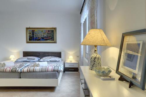 a bedroom with a bed and a lamp and a mirror at Villa Mima in Banjole