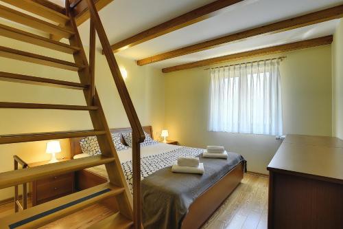 a small bedroom with a bunk bed and a ladder at Villa Maria Betiga in Peroj