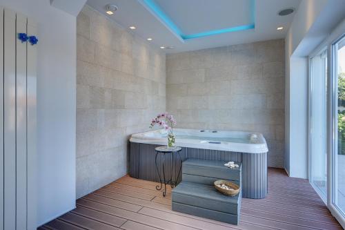 Un baño con bañera y mesa. en Villa Allegra, en Kanfanar