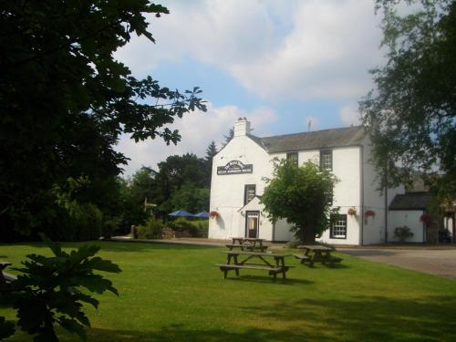 a white building with a picnic table in front of it at Royal Hotel in Dockray