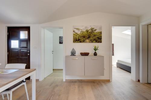 a white kitchen with a table and a dining room at Villa Jela in Medulin