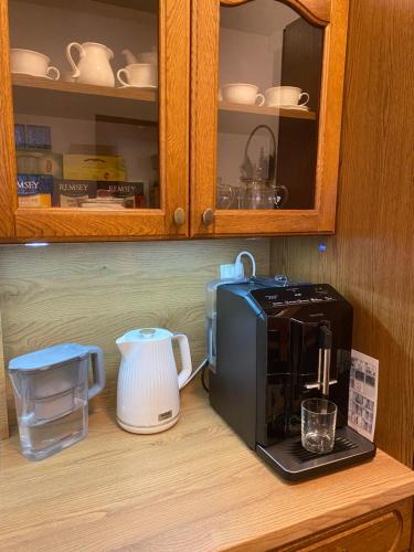 a kitchen counter with a coffee maker and a toaster at Nasze Kamienice Apartament Rodzinny in Rzeszów