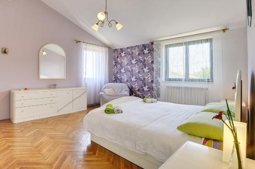 a bedroom with a large bed and a mirror at Einzigartige Villa nur 1 km bis zum Strand mit privatem Pool, BBQ, Klima, WLAN in Ližnjan