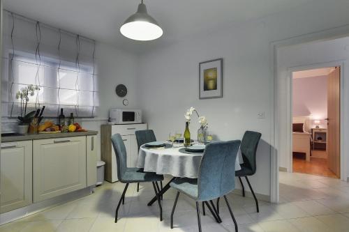 a kitchen and dining room with a table and chairs at Villa Paola in Divšići