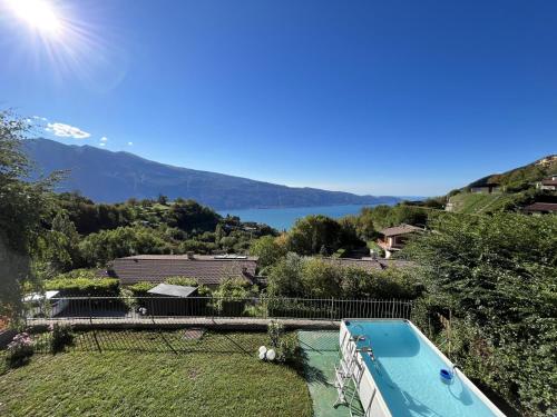 a villa with a swimming pool and a view of a lake at Ferienhaus mit Seeblick und Garten, Pool in ruhiger Lage von Tignale am Gardasee in Tignale