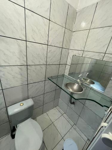 a bathroom with a toilet and a sink at Hotel Horizonte in Teresina